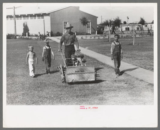 Worker mowing grass at the Agua Fria Migratory Labor Camp, Arizona